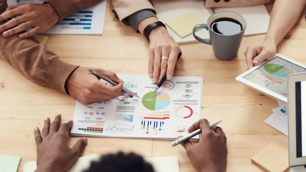 Hands pointing at business structure documents and charts